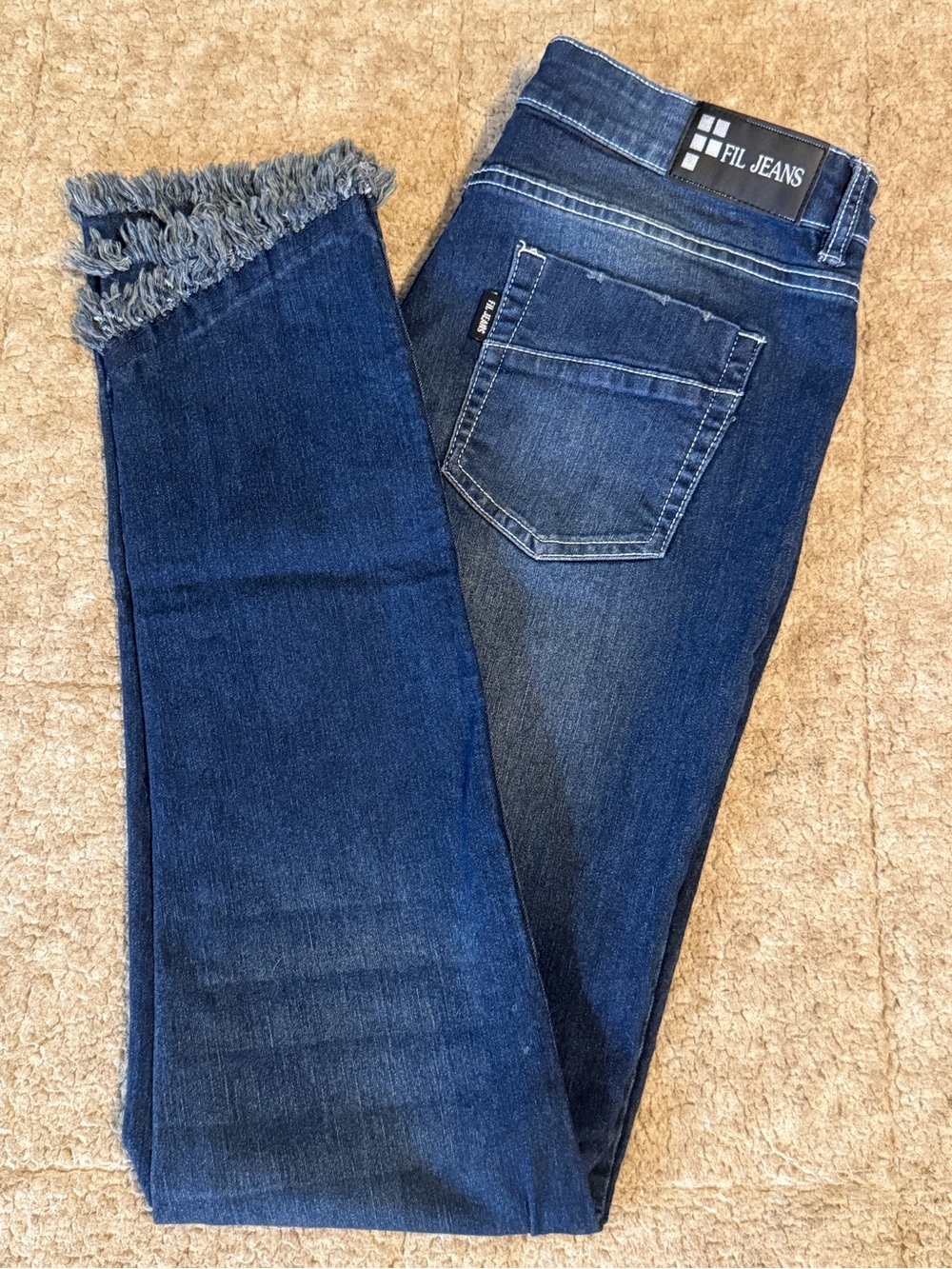 Women's Skinny Dark Blue Jeans with fringe hem.